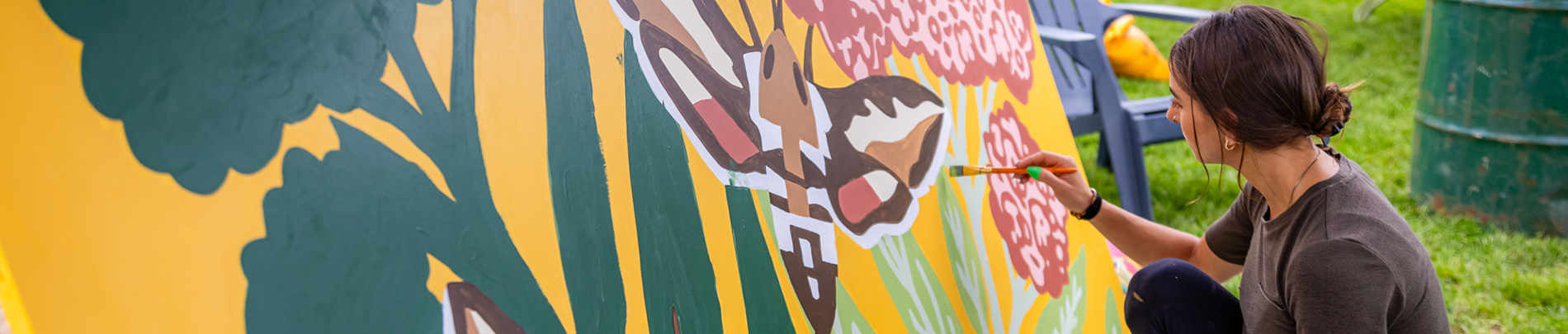 Woman painting a mural