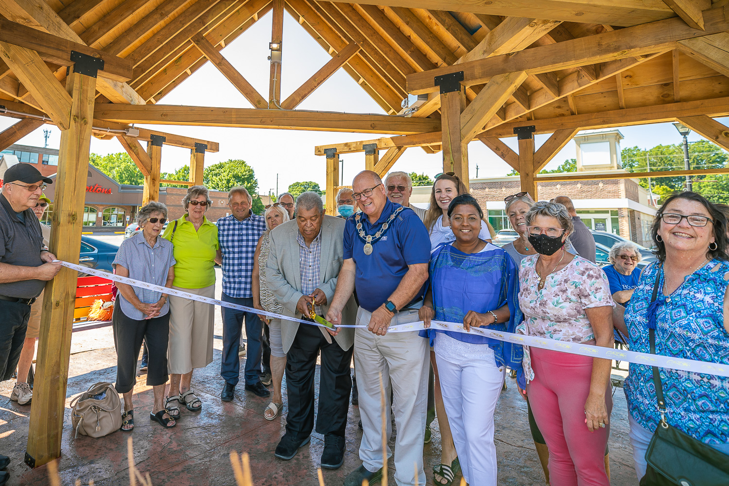 People posing for a photo during ribbon cutting ceremony