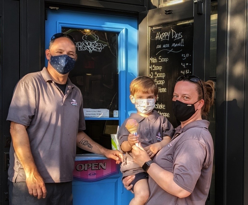 family in front of Happy Days ice cream parlour