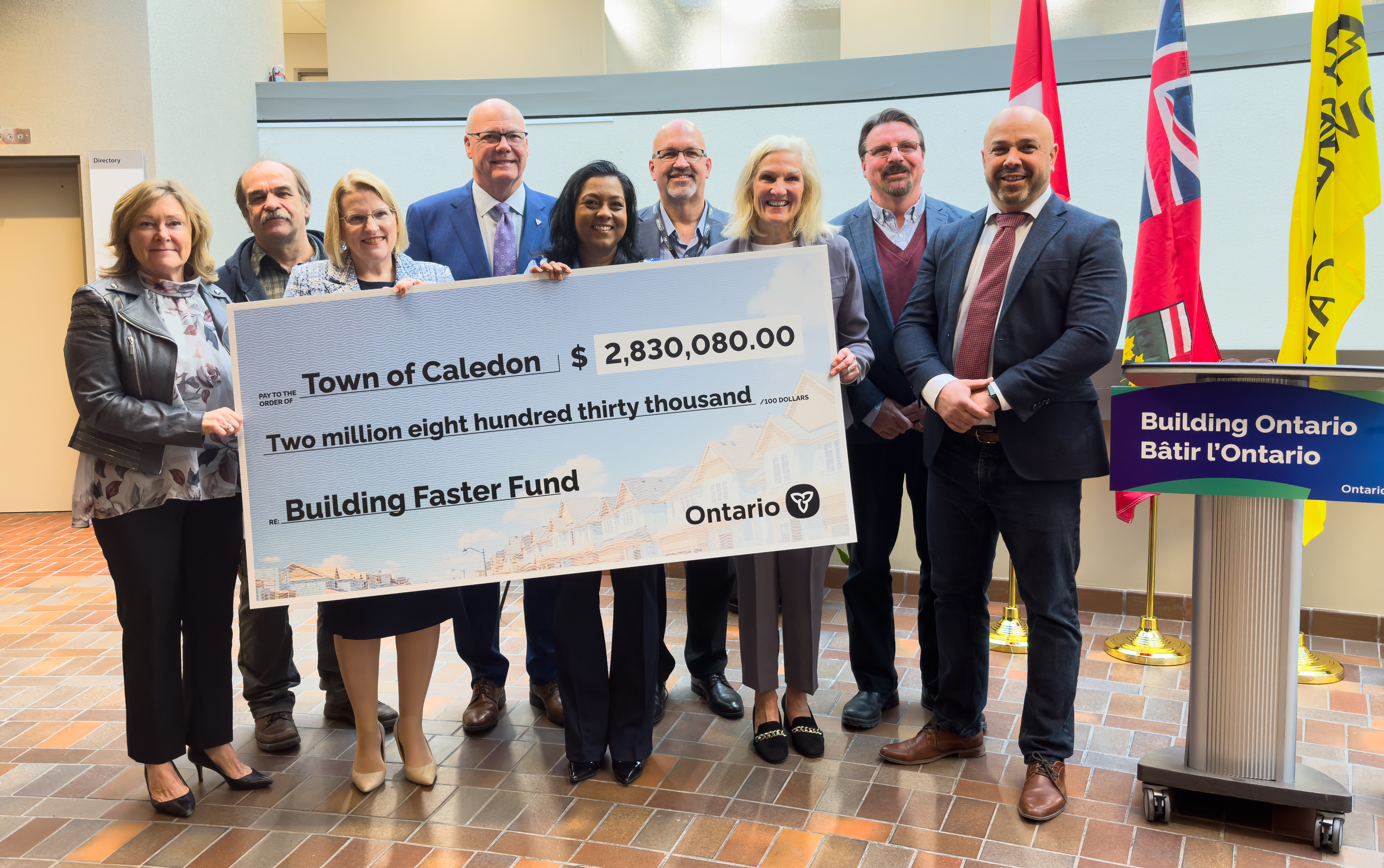 Mayor and Council holding ceremonial cheque from Ontario Government.